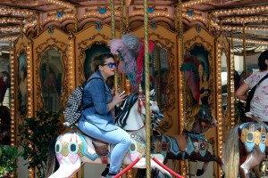 A girl rides on a carousel in Florence, Italy on Friday, June 17, 2016. The carousel is located in the Piazza del Republica, which use to be home to the old Jewish ghettos. (Photograph by Kylie Warren)