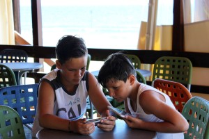 Two boys play videos games in a resturant in Orbetello, Italy on Wednesday, June 15, 2016. Orbetello is apart of Tuscany that is also home to Feniglia Beach. (Photograph by Kylie Warren)